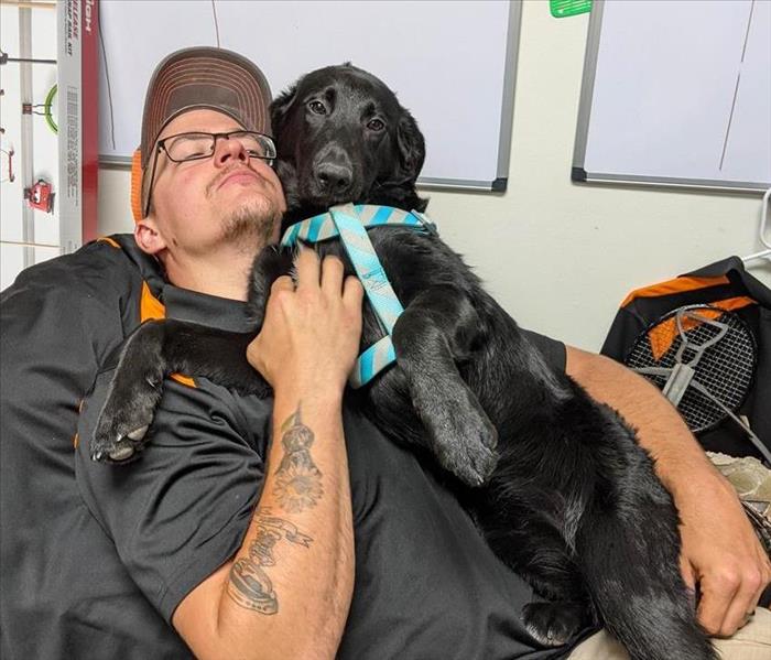 Dog and SERVPRO employee 