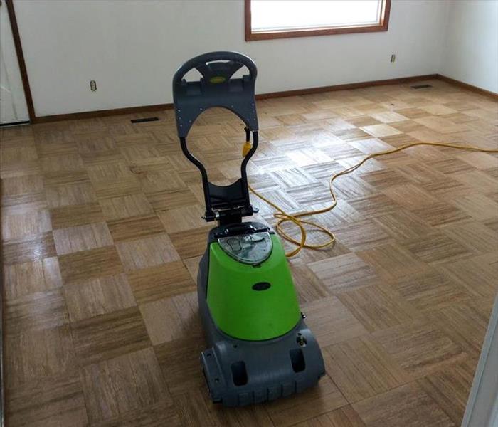 Green SERVPRO equipment on a hardwood floor. 