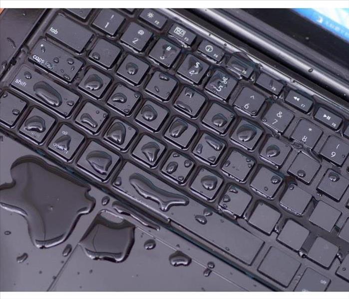 Above view of laptop with water drop damage liquid wet and spill on keyboard, accident concept